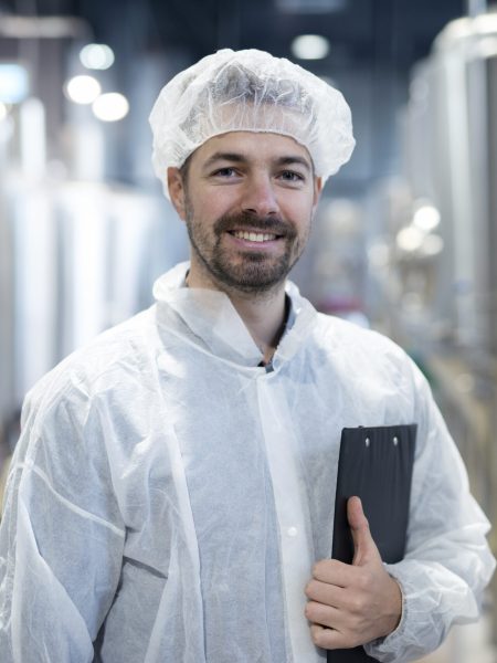 Portrait of smiling technologist in industrial plant.